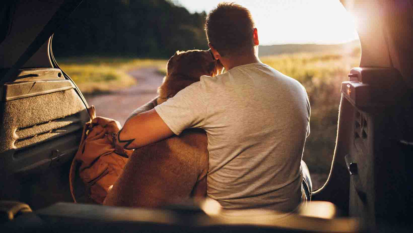 Man cuddling his dog